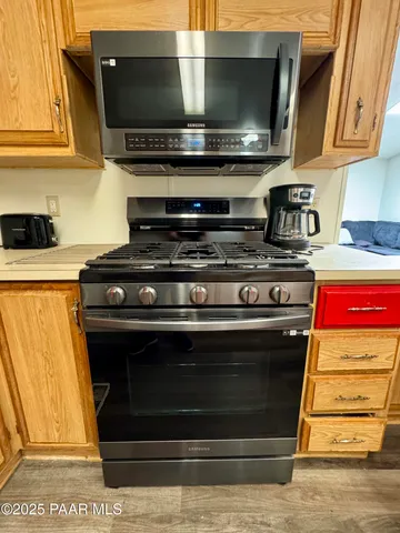 a stove top oven sitting inside of a kitchen
