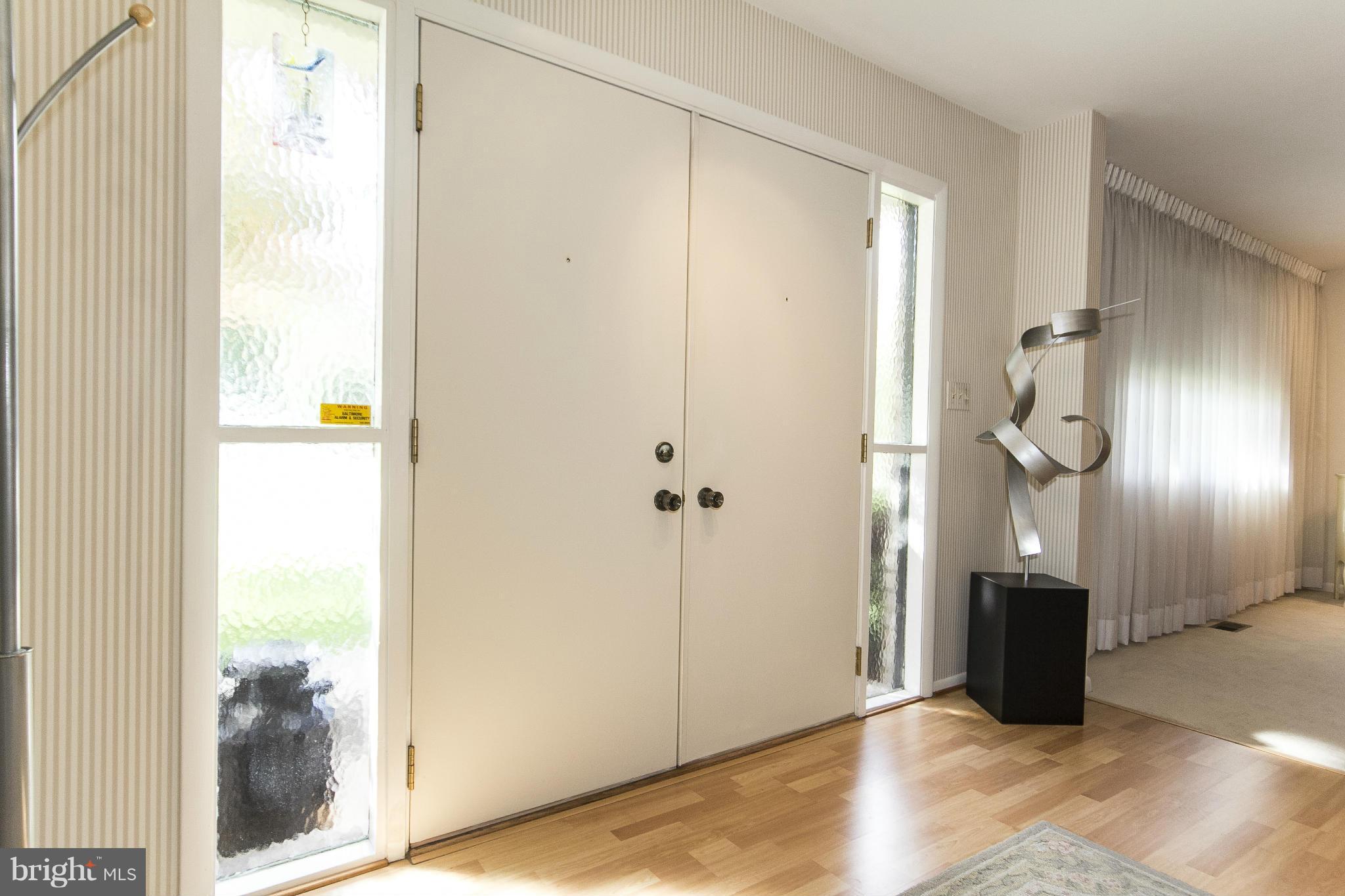 2208 Sugarcone Road Baltimore, MD 21209 - Photo 2 of 23 a view of a hallway with wooden floor and windows