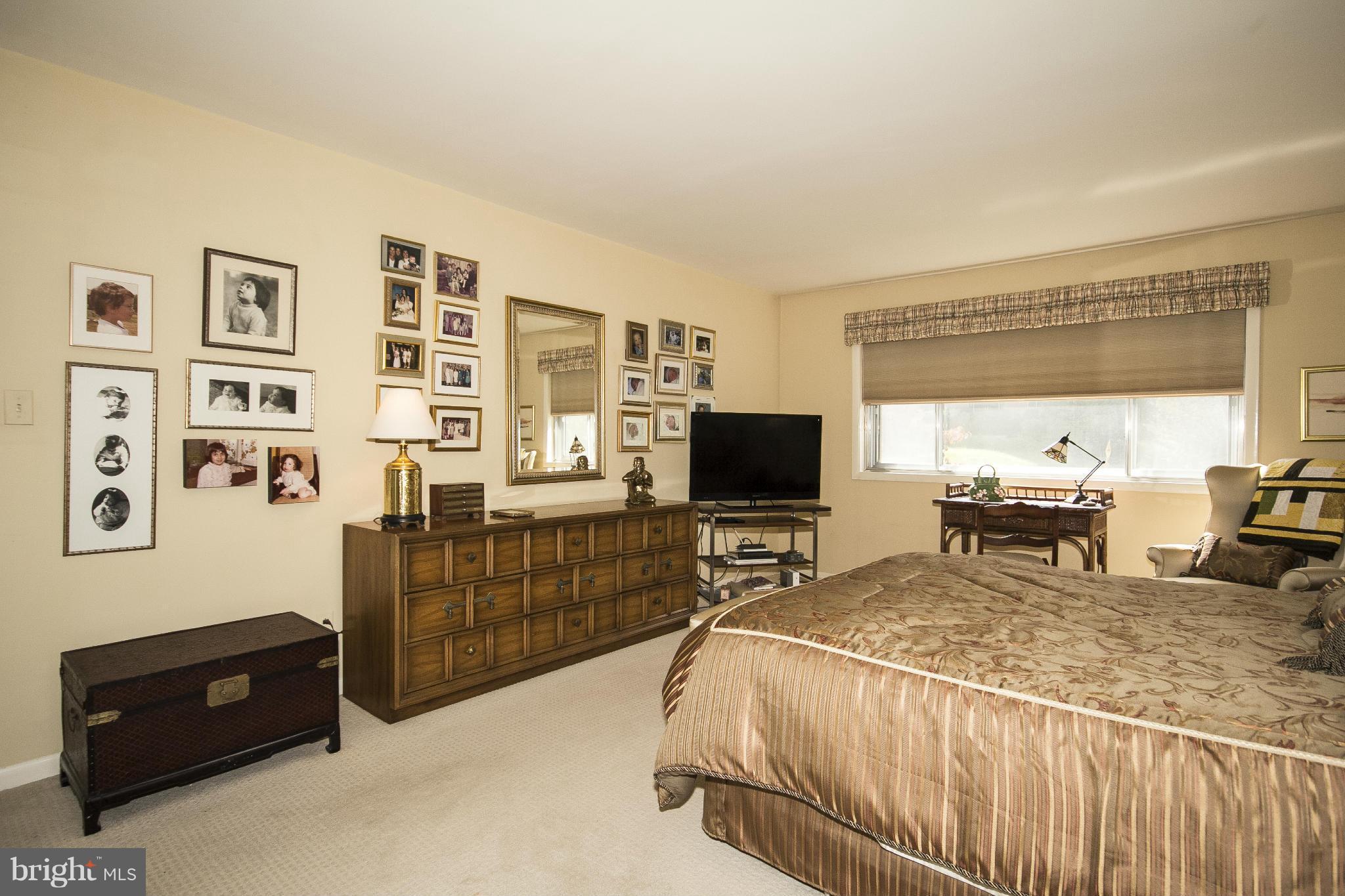 2208 Sugarcone Road Baltimore, MD 21209 - Photo 13 of 23 a bedroom with a bed and a television