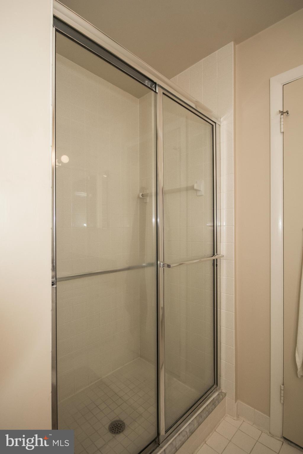 2208 Sugarcone Road Baltimore, MD 21209 - Photo 15 of 23 a bathroom with a glass shower door