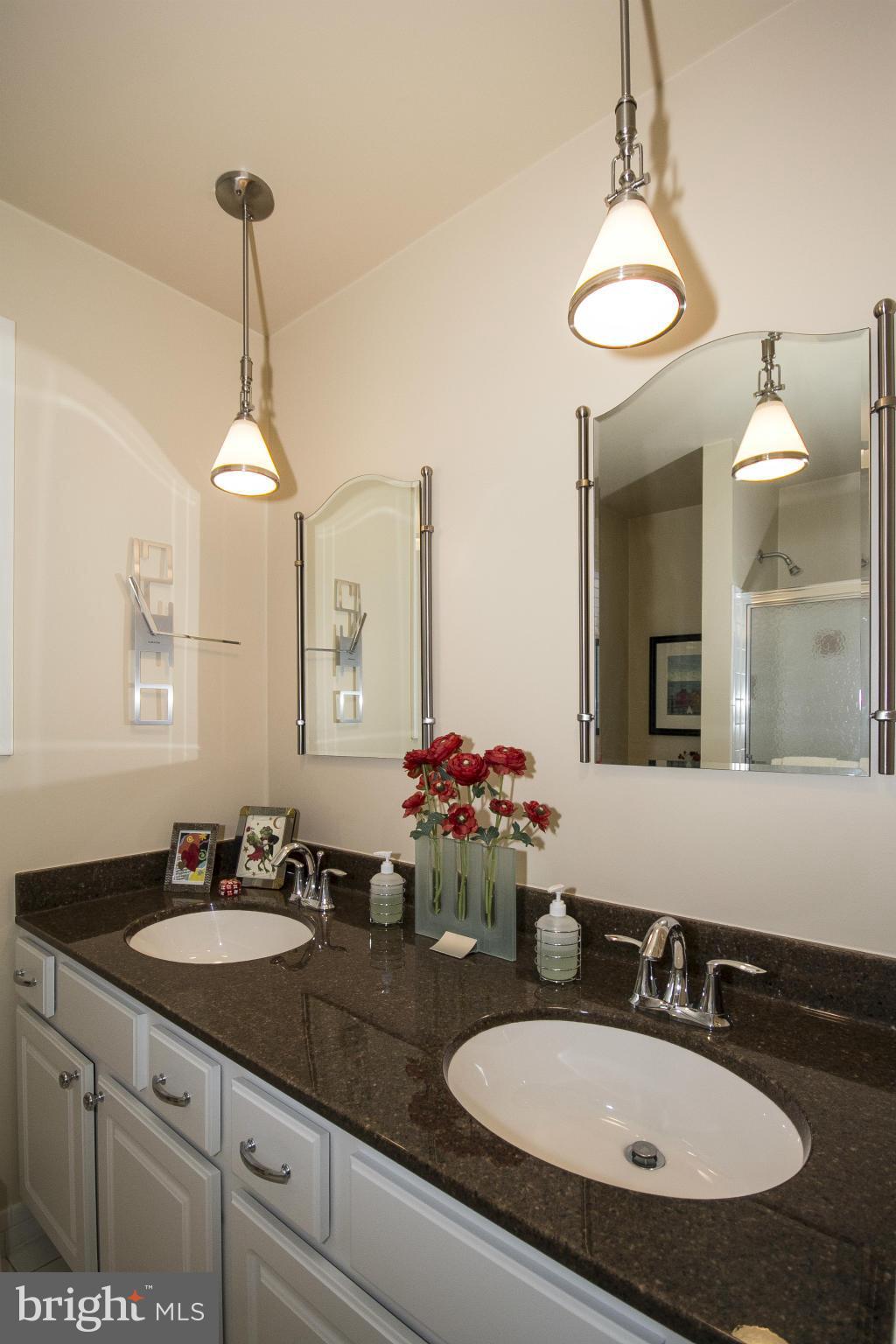 2208 Sugarcone Road Baltimore, MD 21209 - Photo 16 of 23 a bathroom with a sink and a mirror