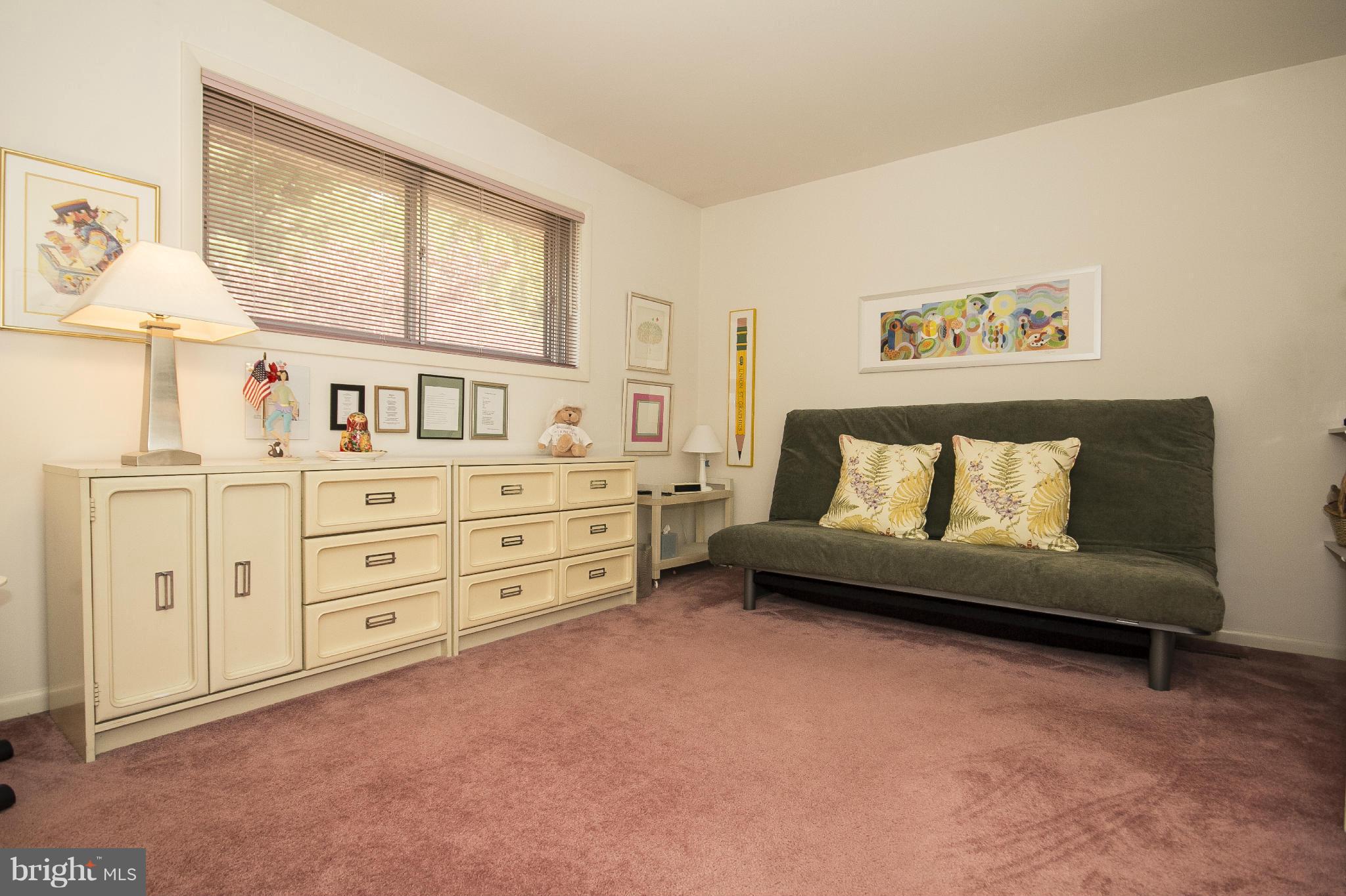 2208 Sugarcone Road Baltimore, MD 21209 - Photo 17 of 23 a spacious bedroom with a bed a couch and dresser