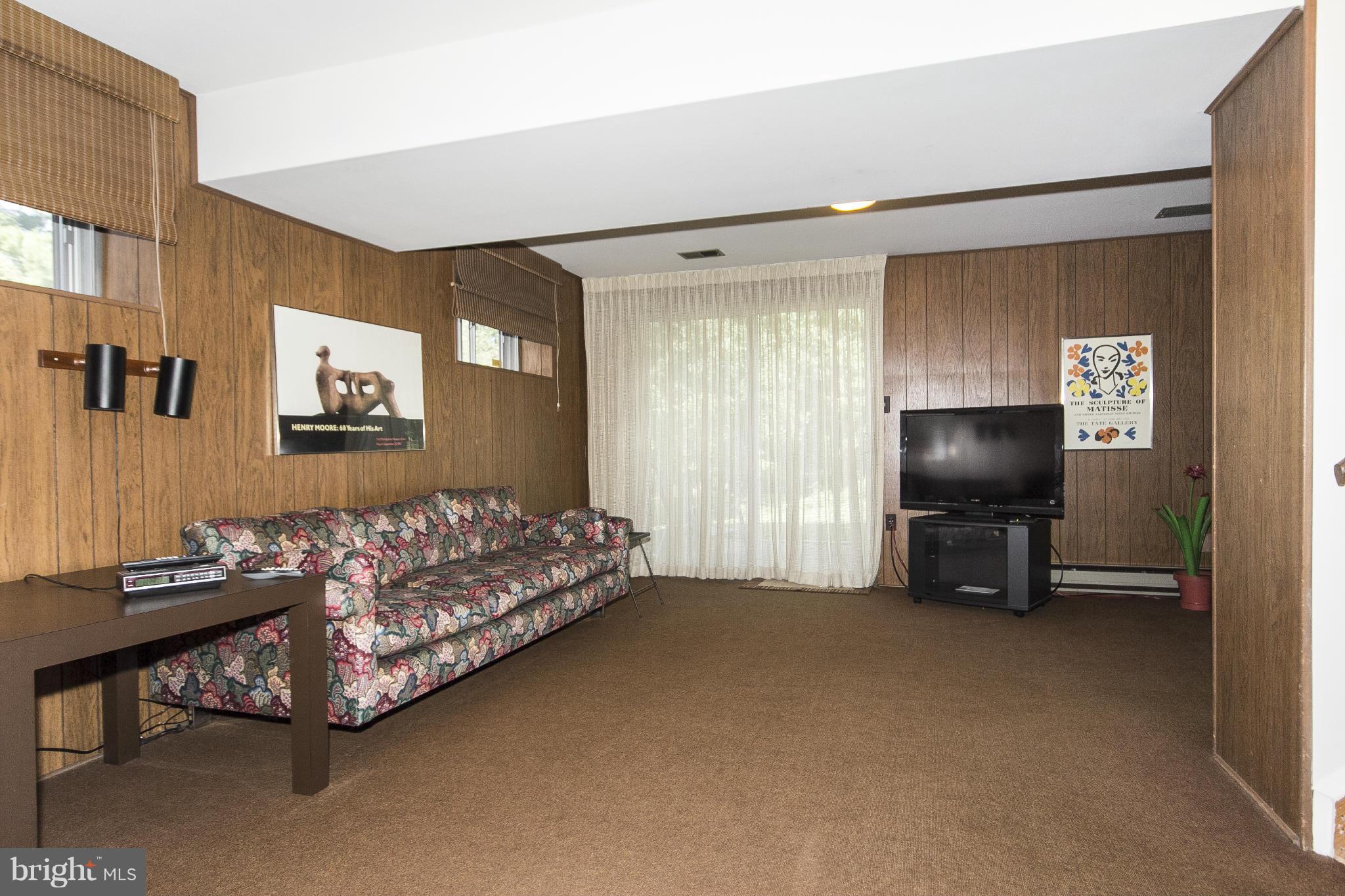 2208 Sugarcone Road Baltimore, MD 21209 - Photo 22 of 23 a living room with furniture and a flat screen tv
