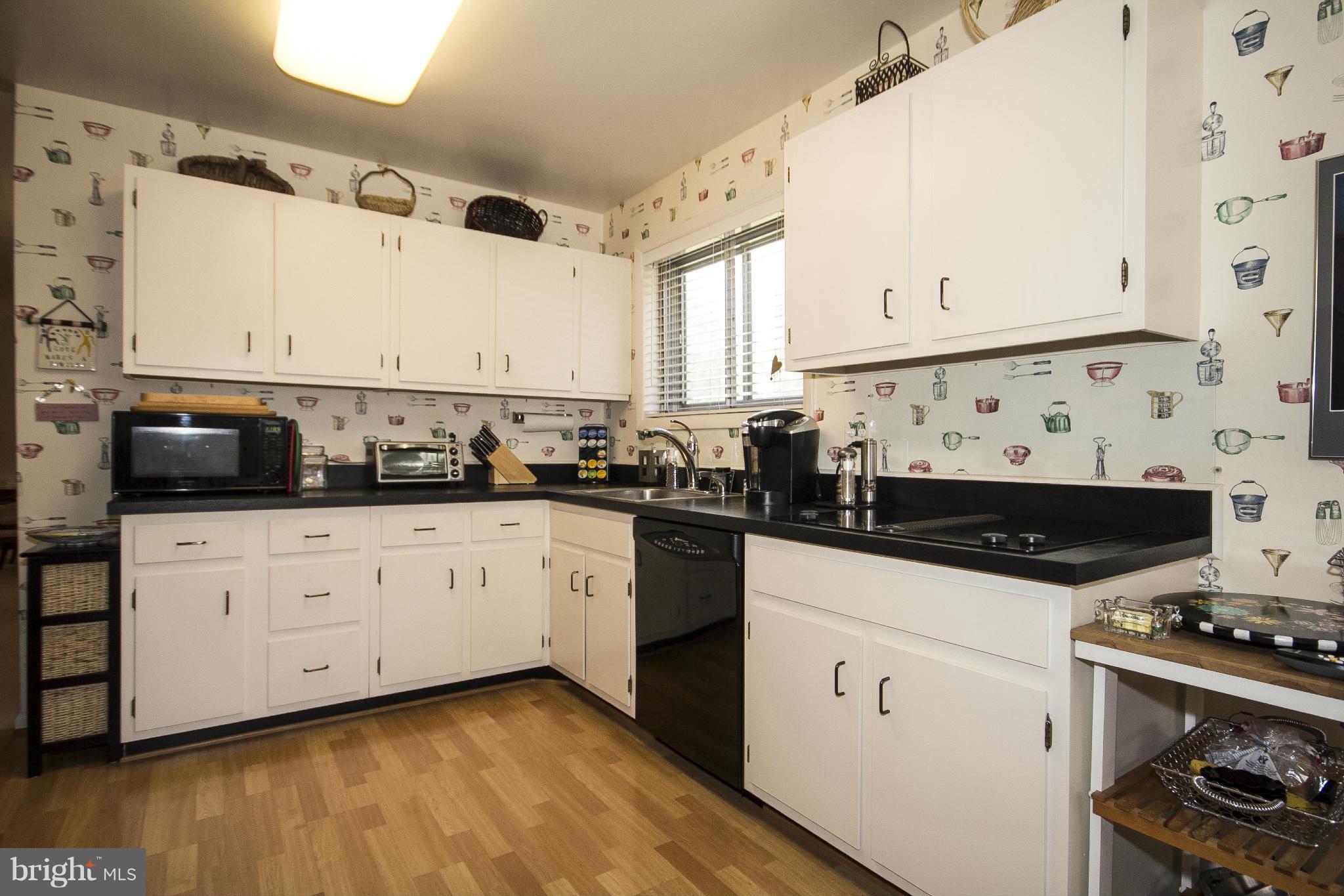 2208 Sugarcone Road Baltimore, MD 21209 - Photo 10 of 23 a kitchen with stainless steel appliances a sink and a stove