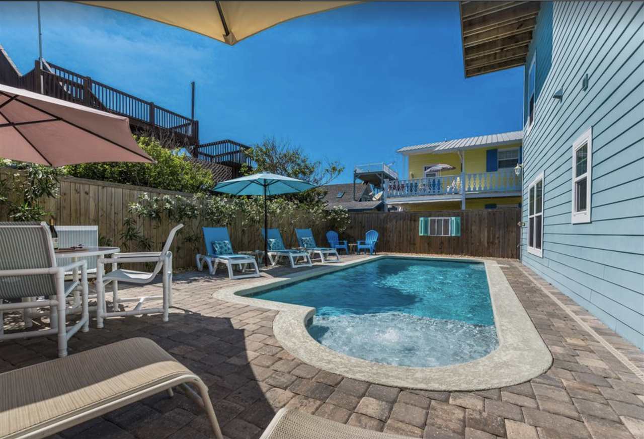 5349 Atlantic View St. Augustine, FL 32080 - Photo 15 of 33 a view of a patio with a table and chairs under an umbrella