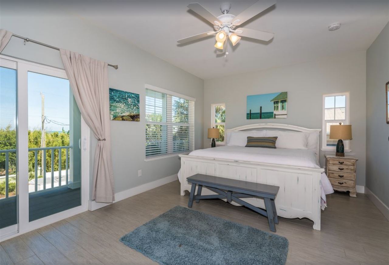 5349 Atlantic View St. Augustine, FL 32080 - Photo 17 of 33 a spacious bedroom with a large bed and a chandelier