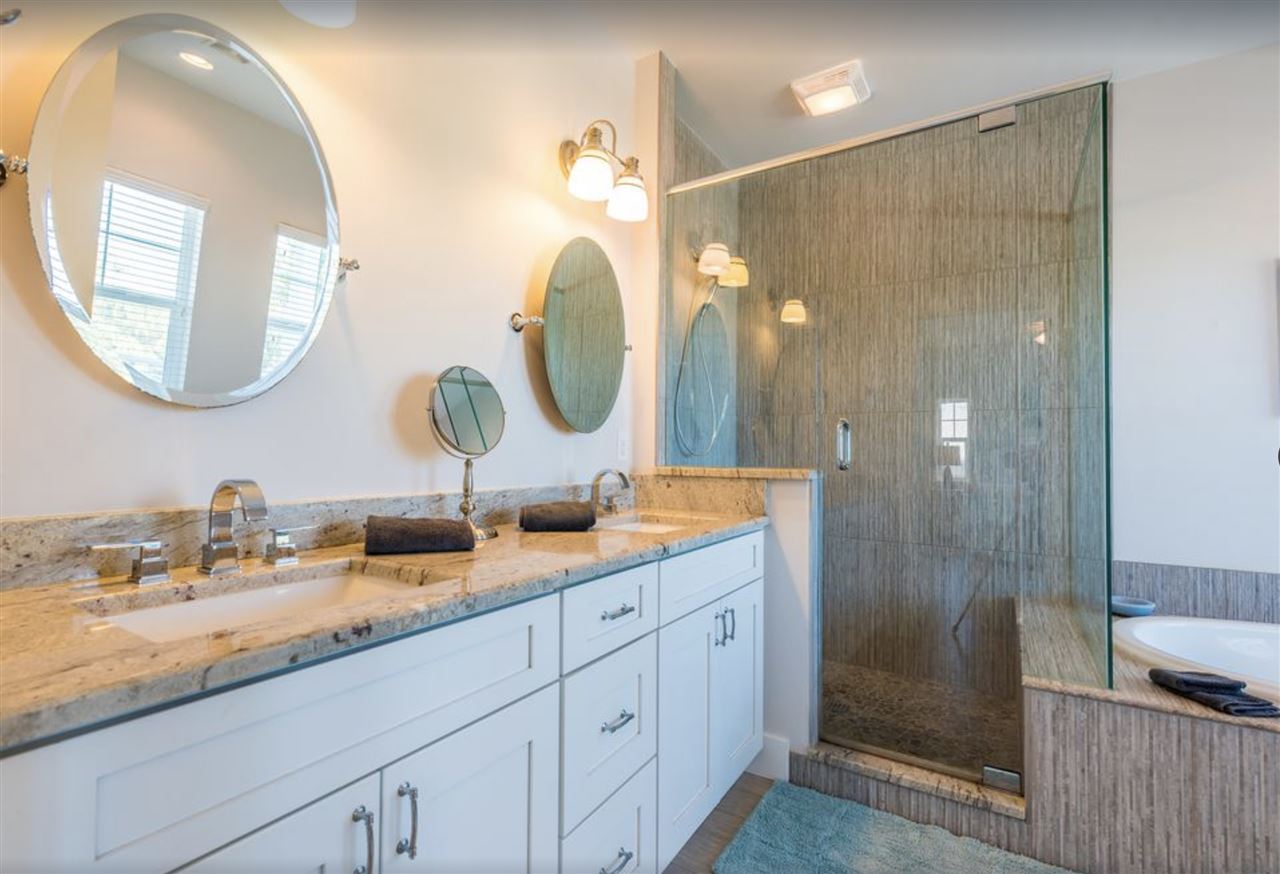 5349 Atlantic View St. Augustine, FL 32080 - Photo 18 of 33 a bathroom with a double vanity sink and a mirror