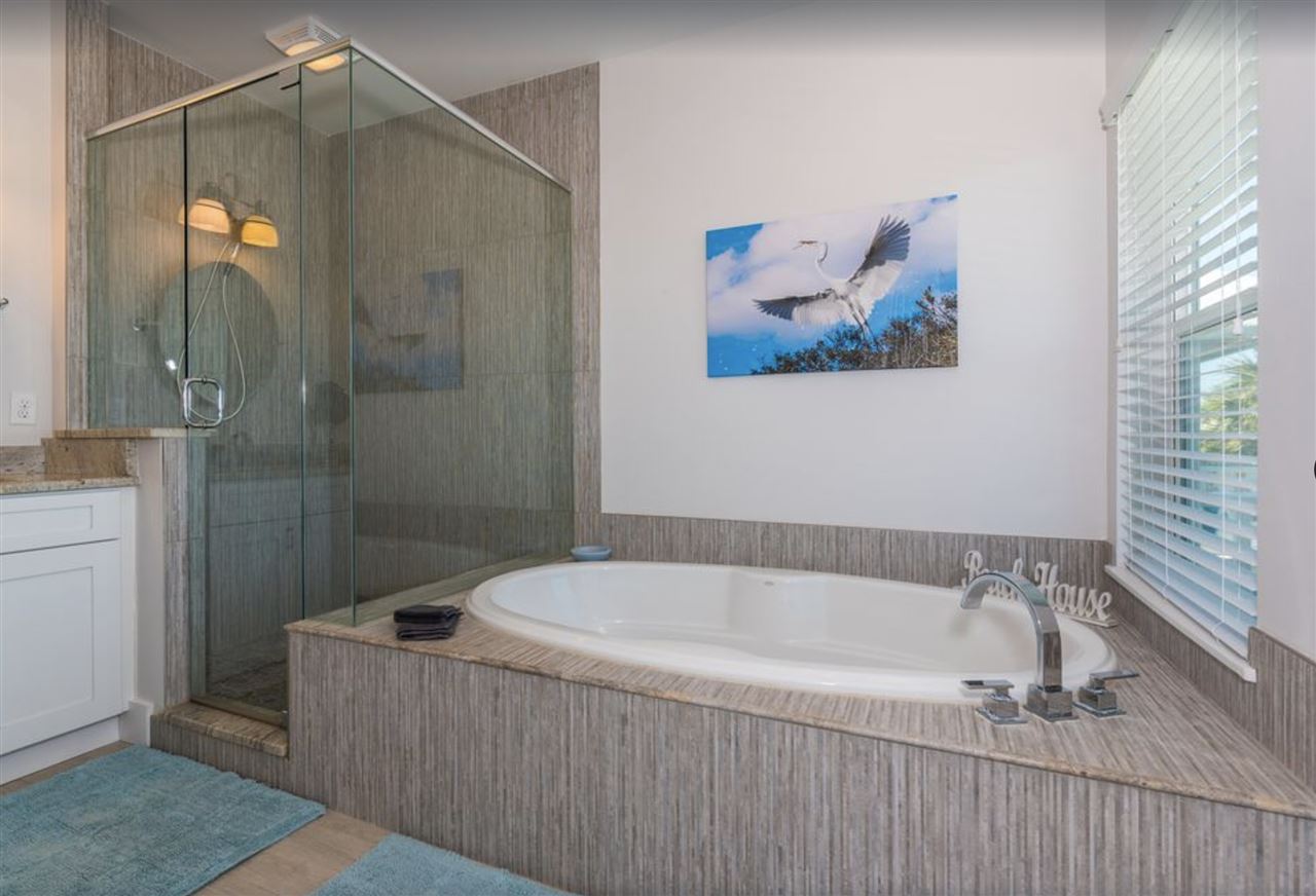 5349 Atlantic View St. Augustine, FL 32080 - Photo 19 of 33 a bathroom with a tub and a shower