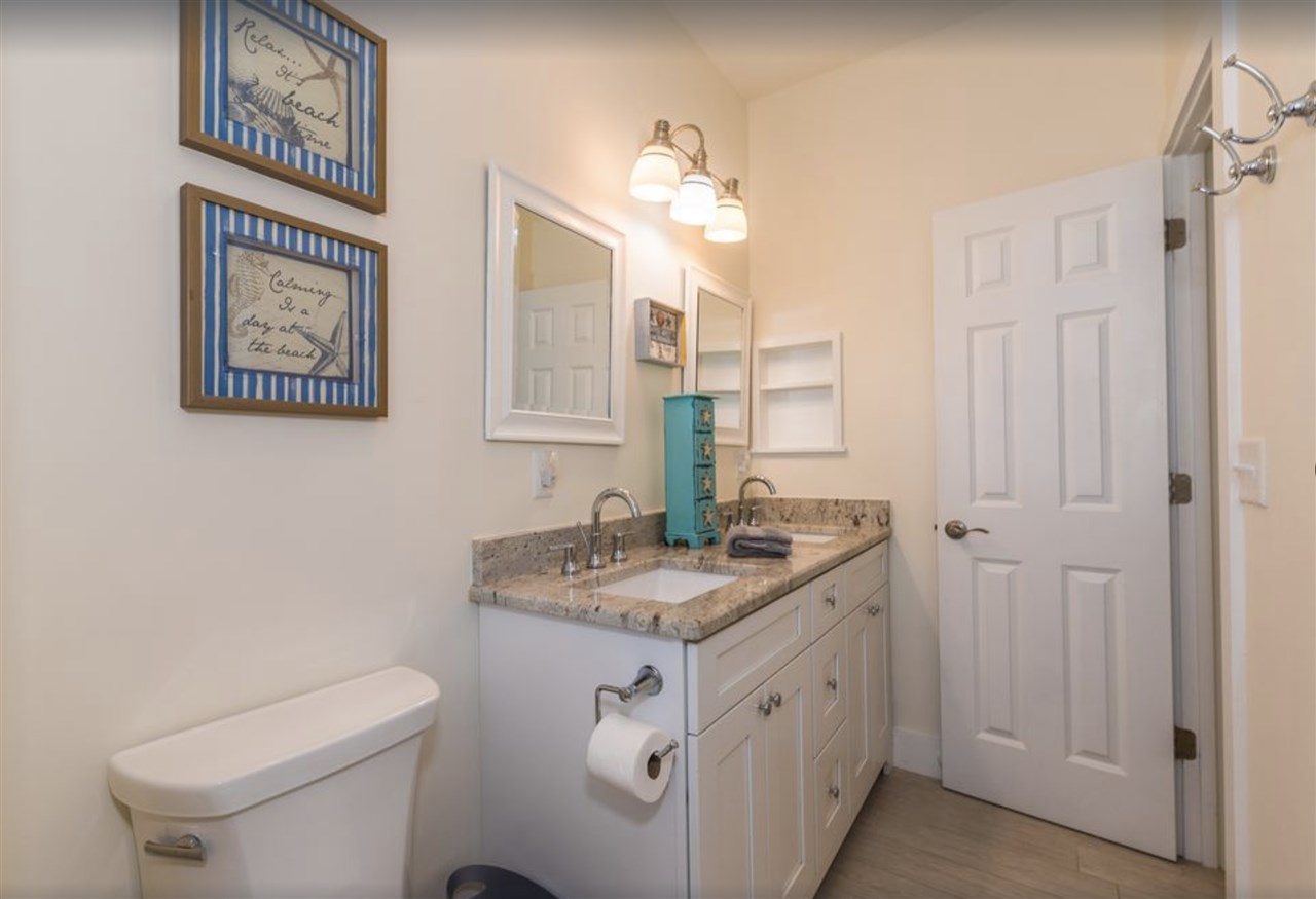 5349 Atlantic View St. Augustine, FL 32080 - Photo 22 of 33 a spacious bathroom with a granite countertop sink a toilet a mirror and shower