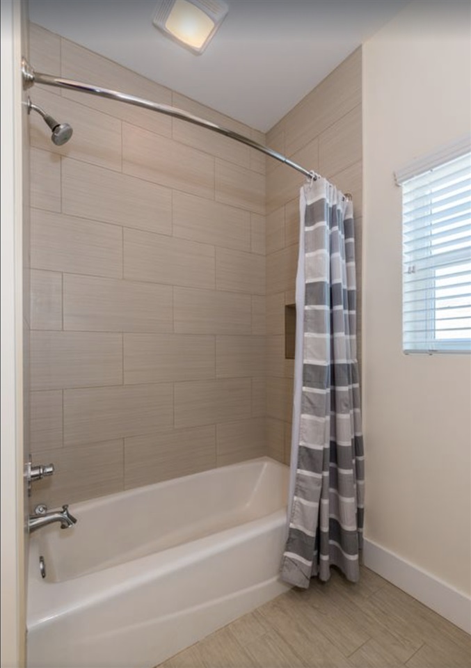 5349 Atlantic View St. Augustine, FL 32080 - Photo 23 of 33 a bathroom with a bathtub and a shower