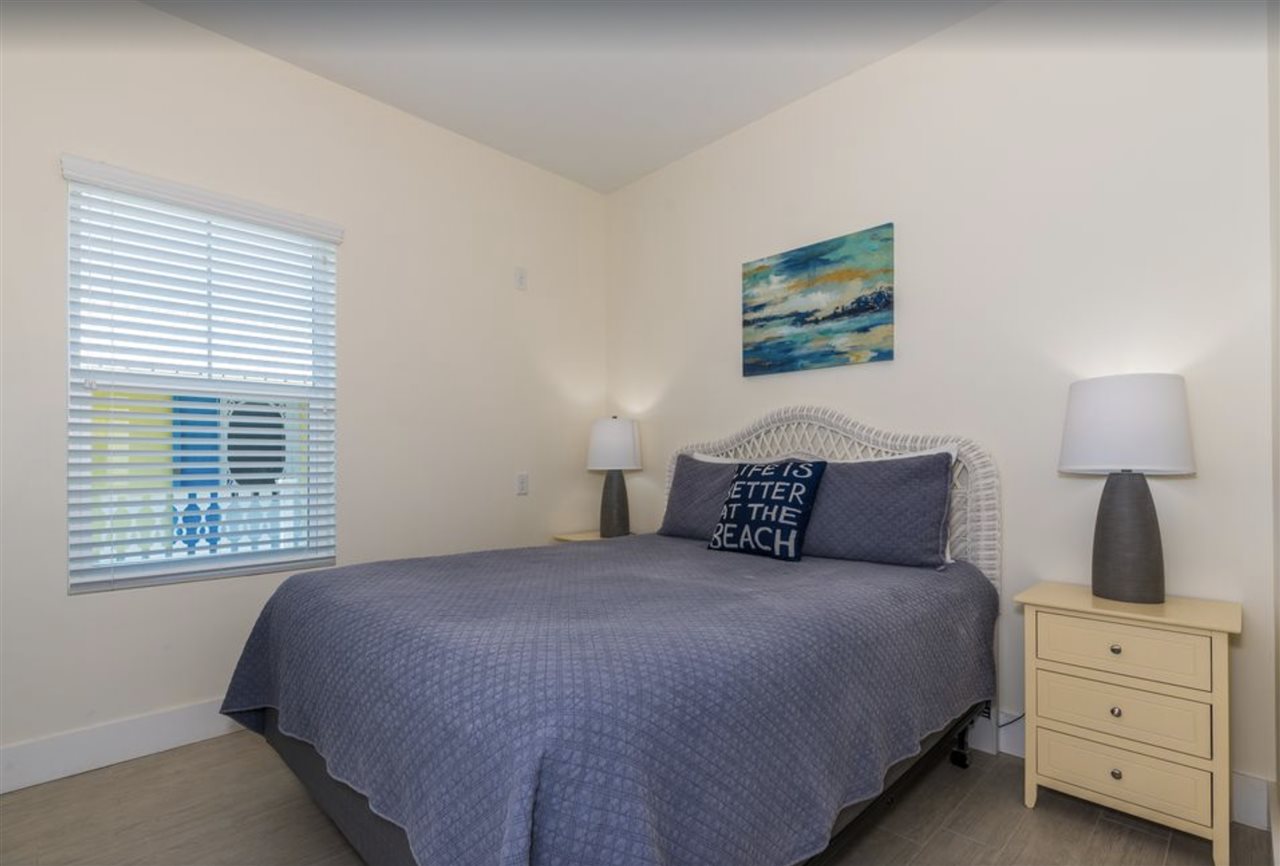 5349 Atlantic View St. Augustine, FL 32080 - Photo 24 of 33 a bedroom with a large bed and a window