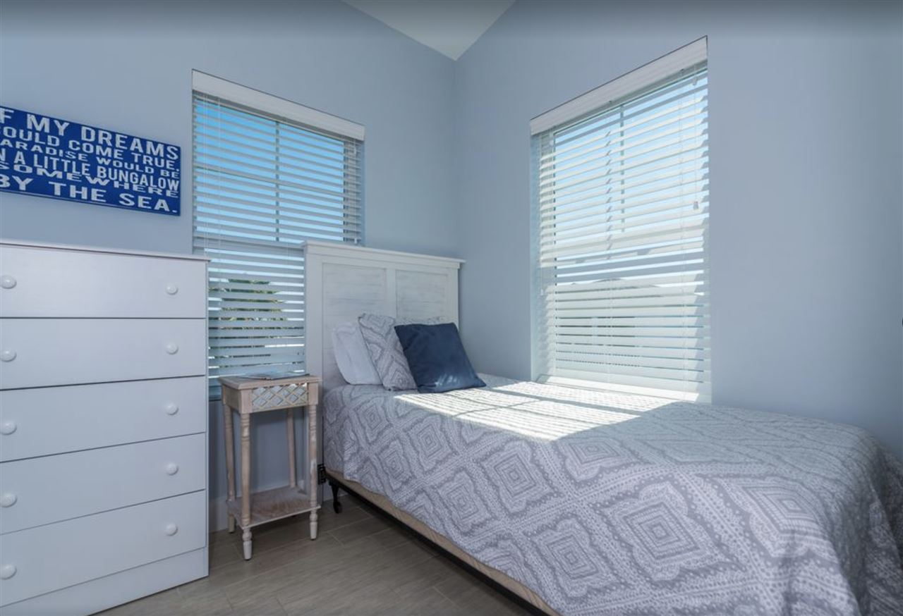 5349 Atlantic View St. Augustine, FL 32080 - Photo 29 of 33 a bedroom with a bed and a window