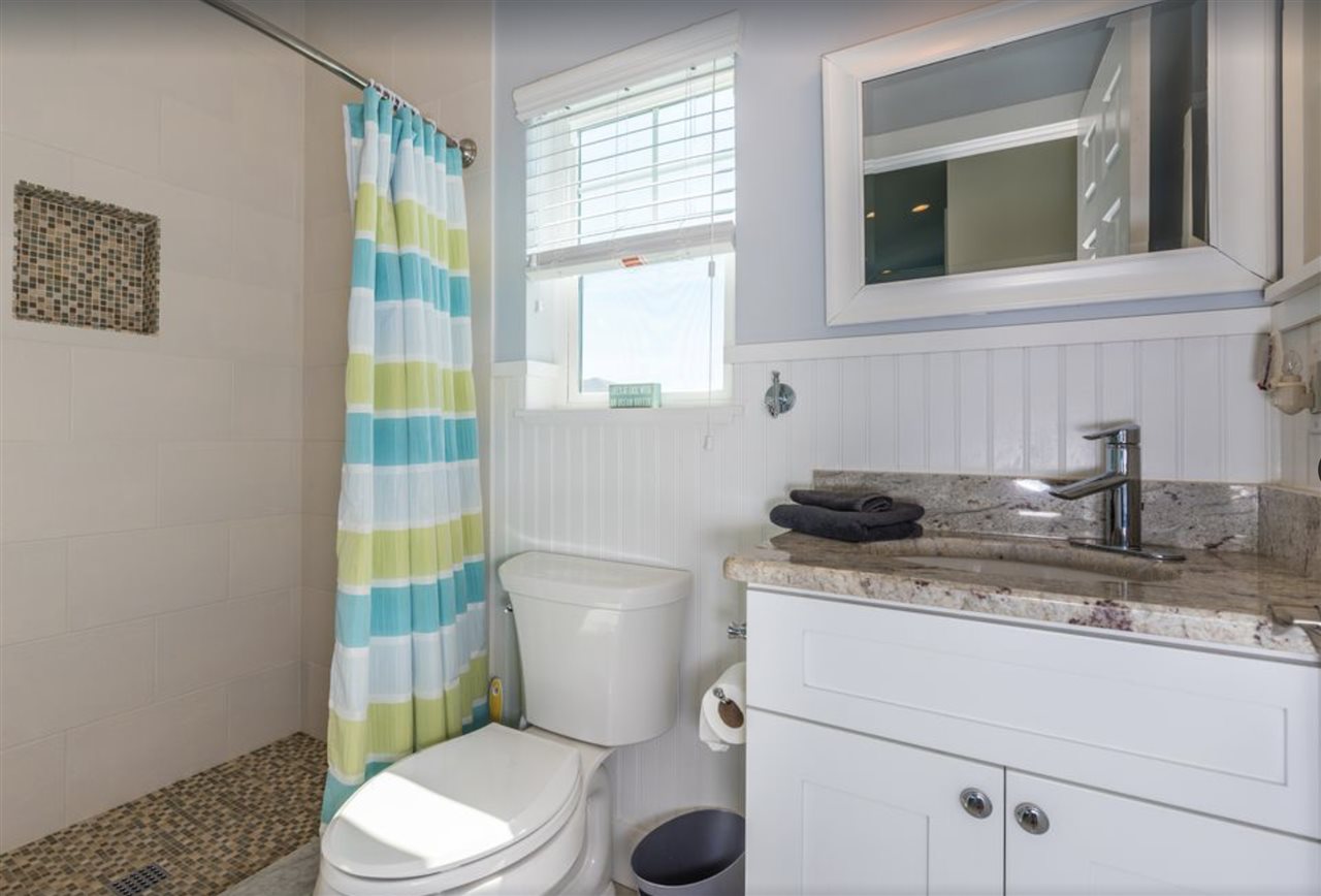 5349 Atlantic View St. Augustine, FL 32080 - Photo 30 of 33 a bathroom with a granite countertop toilet sink and mirror