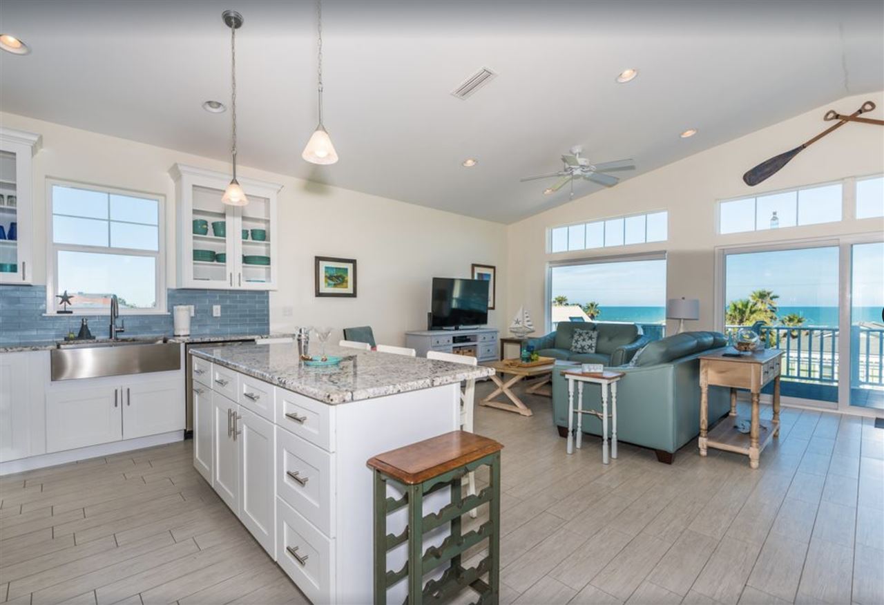 5349 Atlantic View St. Augustine, FL 32080 - Photo 10 of 33 a open kitchen with stainless steel appliances granite countertop a lot of cabinets a sink dishwasher a dining table and chairs with wooden floor