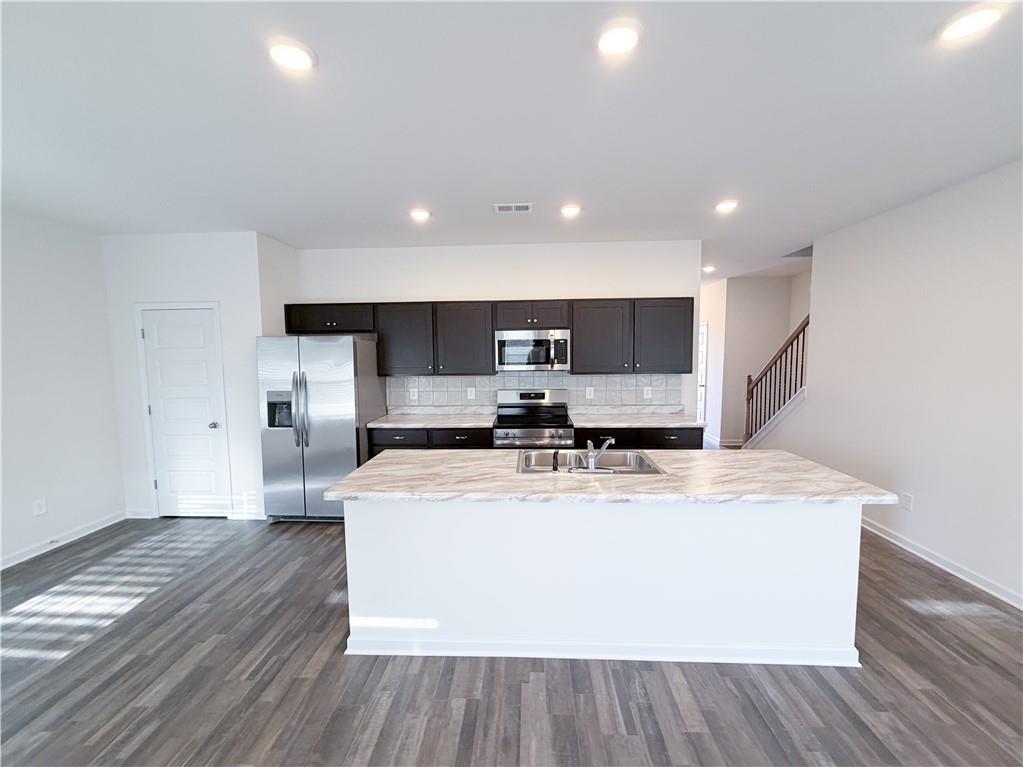 145 Red Oak Lane Calhoun, GA 30701 - Photo 3 of 18 a large white kitchen with wooden floor