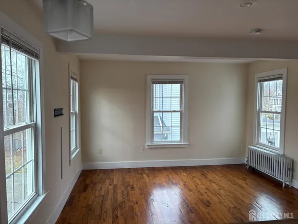 a bedroom with furniture and a flat screen tv
