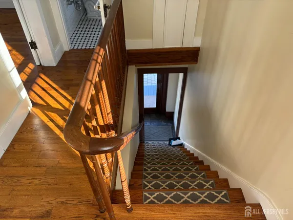 a view of entryway and hall with wooden floor