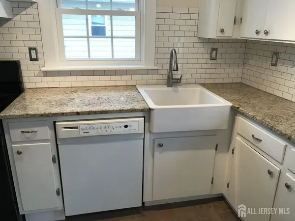 a kitchen that has a sink and a stove in it