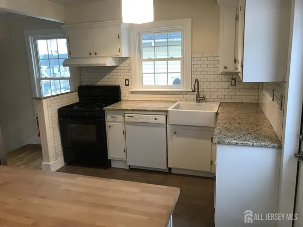 a view of a living room and wooden floor
