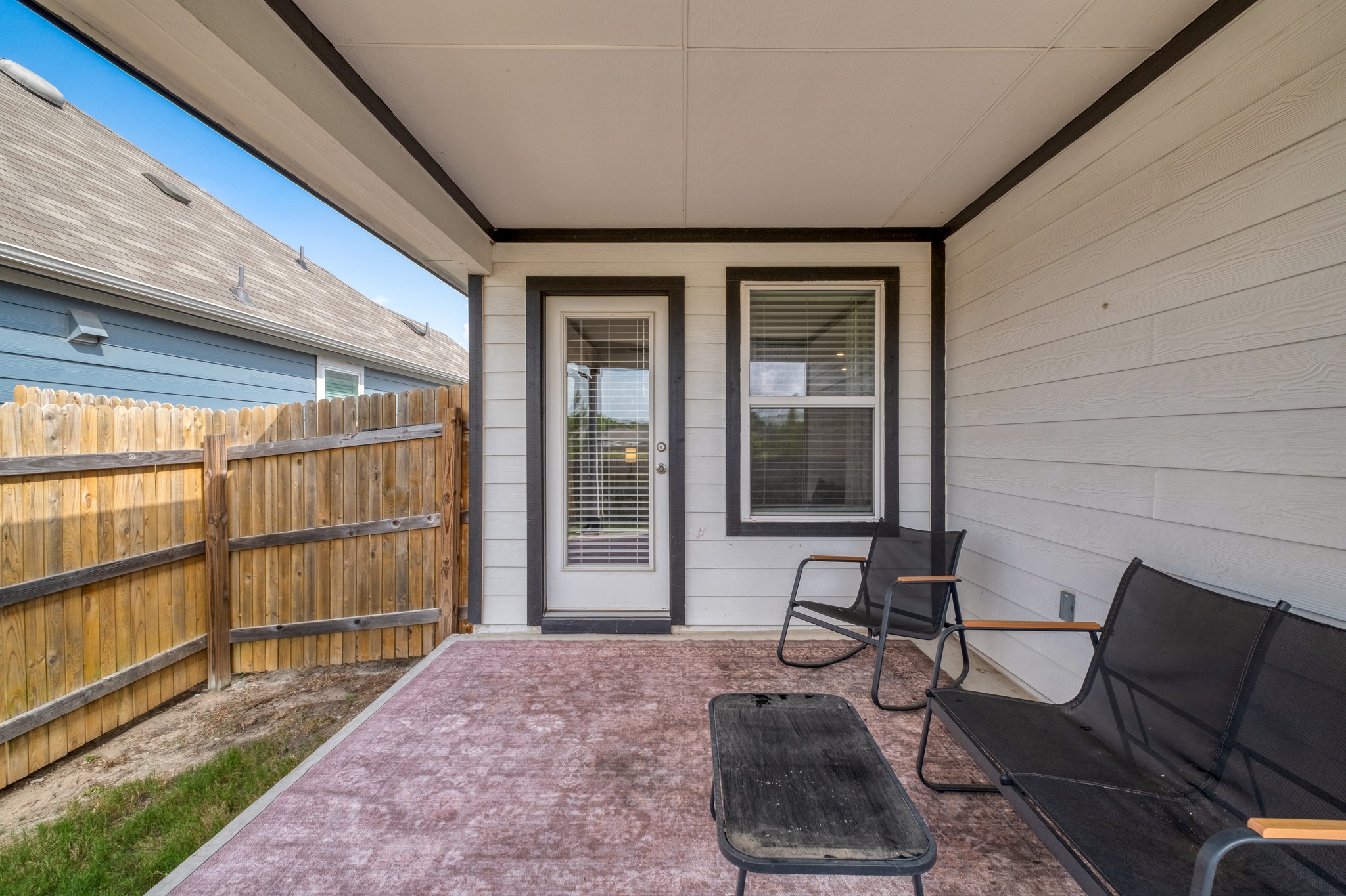 102 Johnson Draw Road Hutto, TX 78634 - Photo 25 of 30 An inviting covered patio offers a sheltered outdoor space alongside a fenced backyard.
