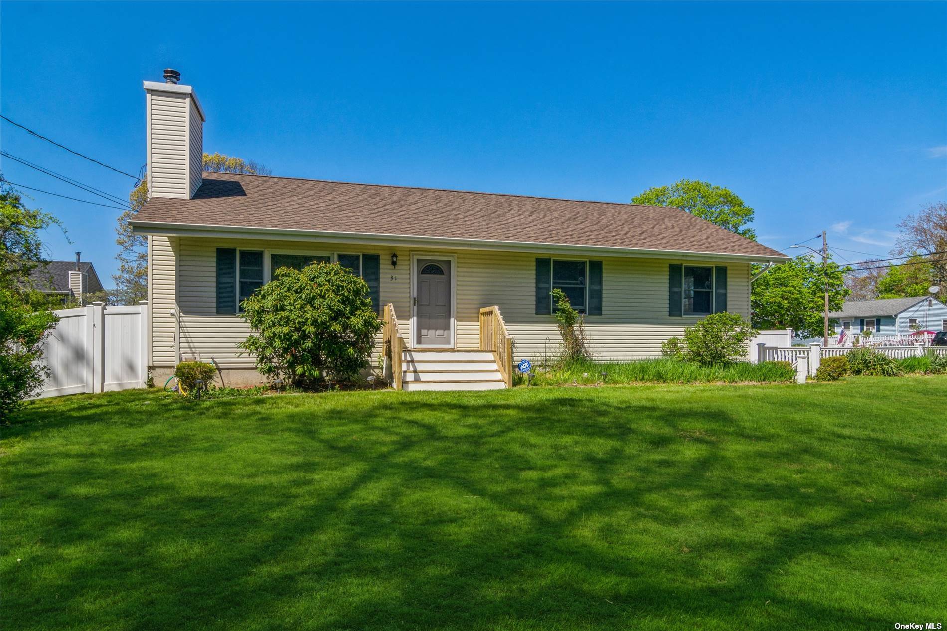 31 Naiad Road Rocky Point, NY 11778 - Photo 1 of 1 a front view of a house with a garden and yard