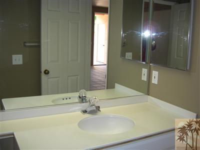 401 El Cielo Road, Unit 227 Palm Springs, CA 92262 - Photo 13 of 24 a bathroom with a sink and a large mirror