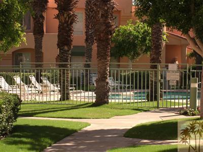 401 El Cielo Road, Unit 227 Palm Springs, CA 92262 - Photo 18 of 24 a view of a house with a small yard and a large trees