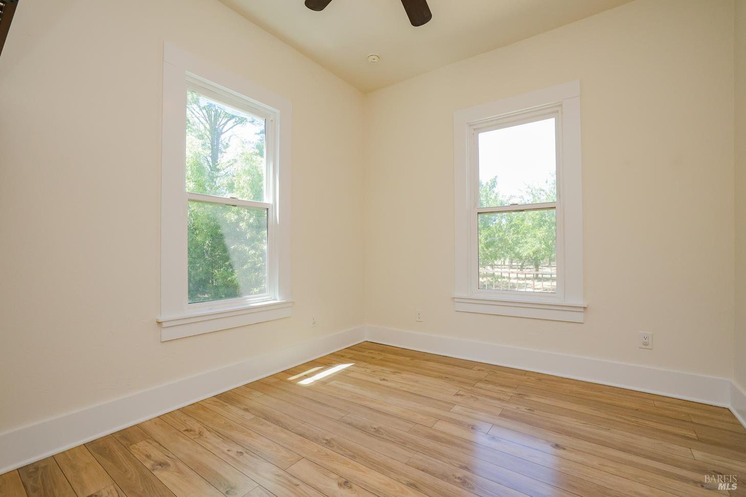 7948 North Meridian Road Dixon, CA 95620 - Photo 20 of 59 an empty room with wooden floor and windows