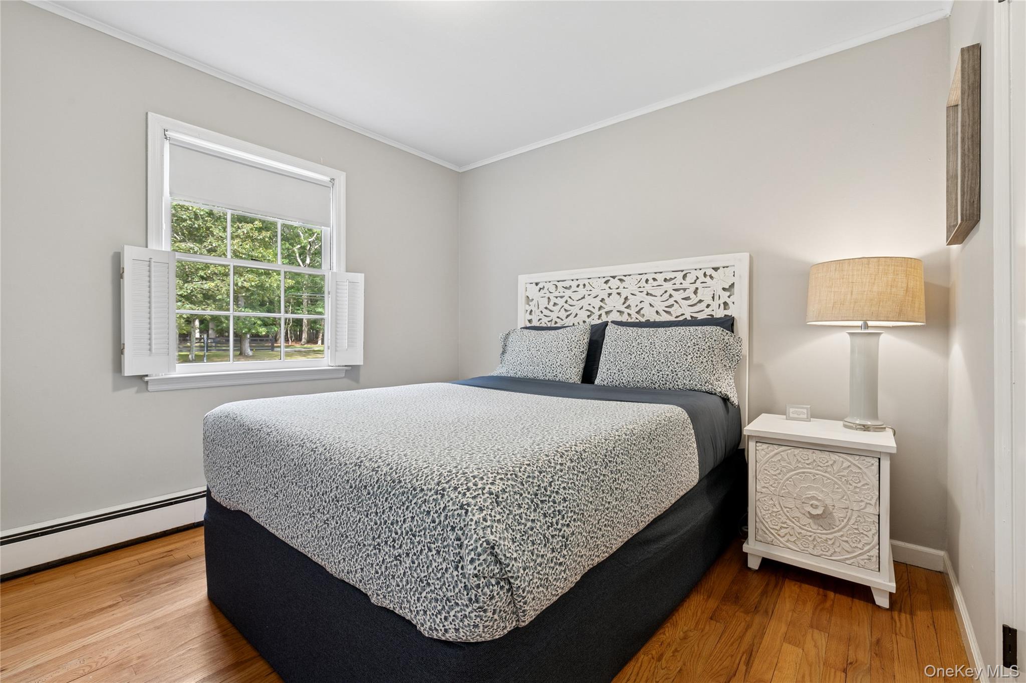 1181 Fireplace Road East Hampton, NY 11937 - Photo 13 of 26 a bedroom with a bed and wooden floor