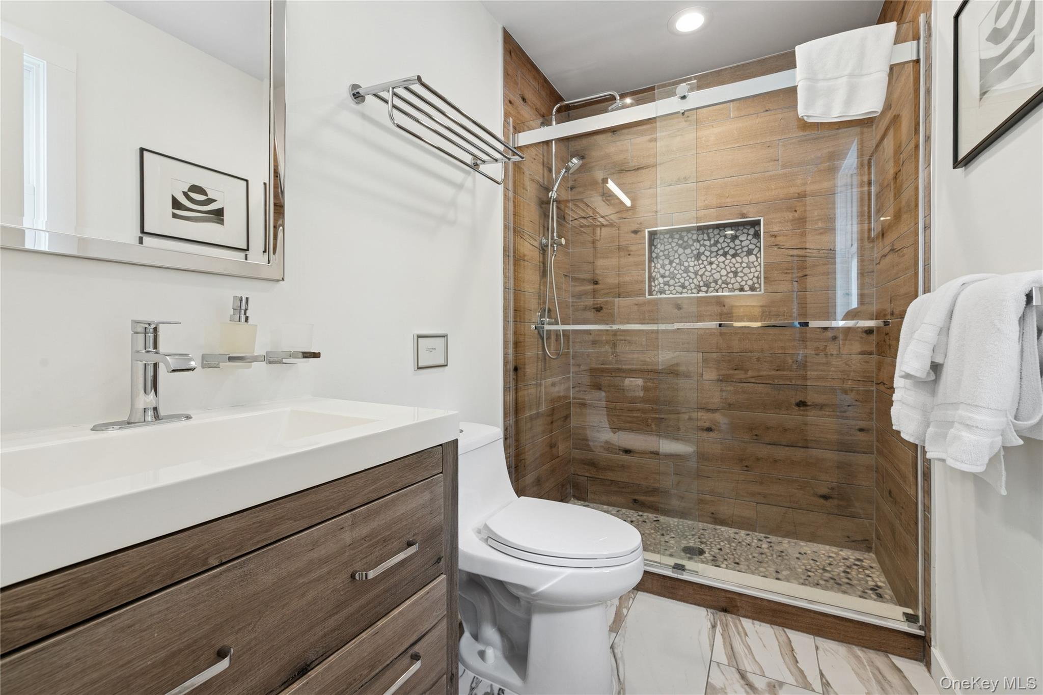 1181 Fireplace Road East Hampton, NY 11937 - Photo 18 of 26 a bathroom with a sink a toilet and shower