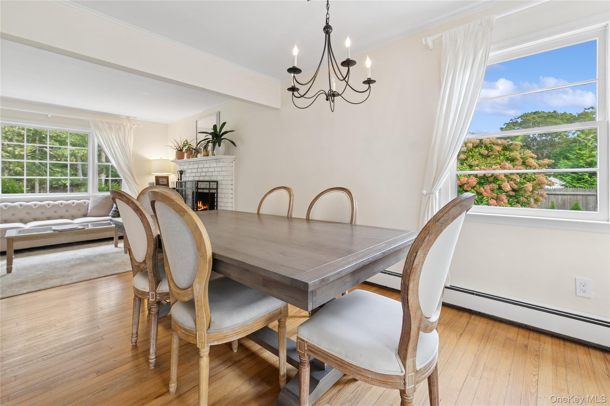 1181 Fireplace Road East Hampton, NY 11937 - Photo 4 of 26 a view of a dining room with furniture a chandelier and wooden floor