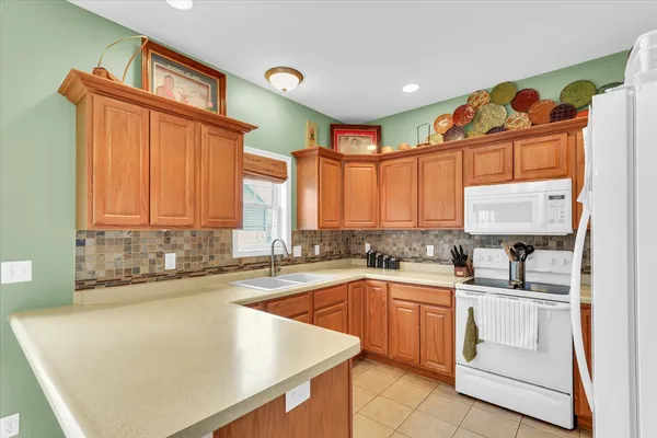 a kitchen with a sink a stove and cabinets