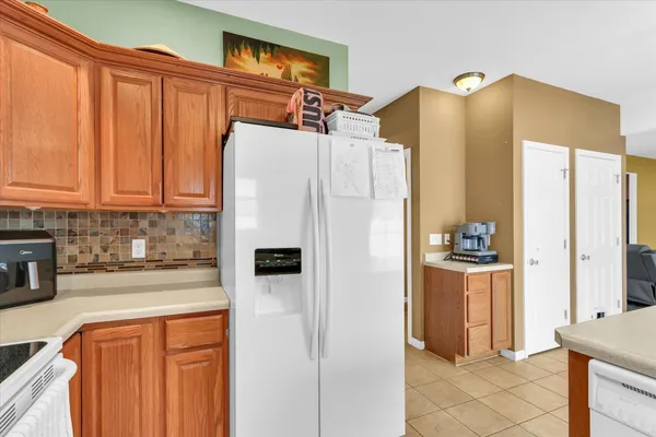 a white refrigerator freezer sitting in a kitchen