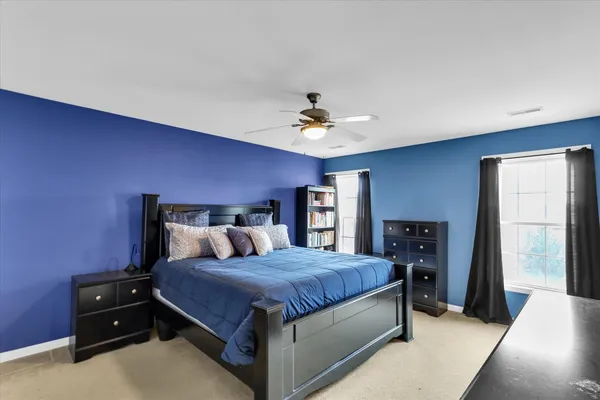 a bedroom with a bed and window