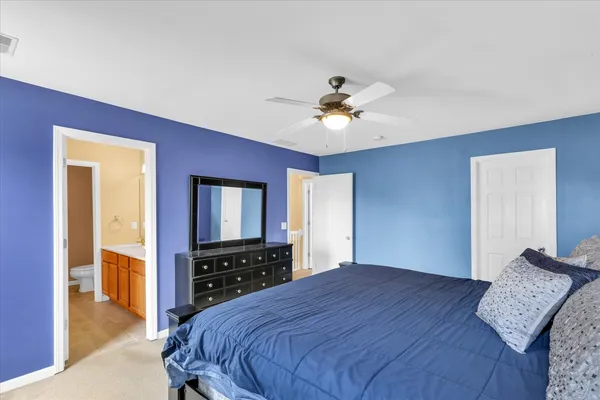 a bedroom with a bed and a dresser