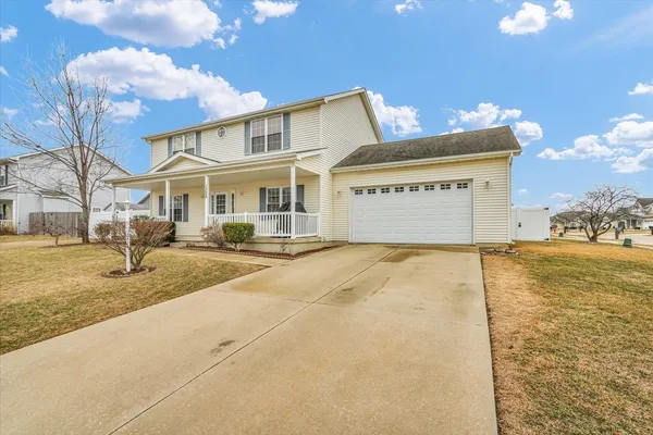 a front view of a building with a yard