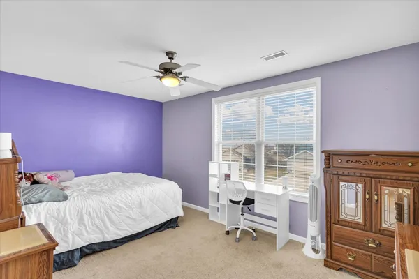 a bedroom with a bed and a table
