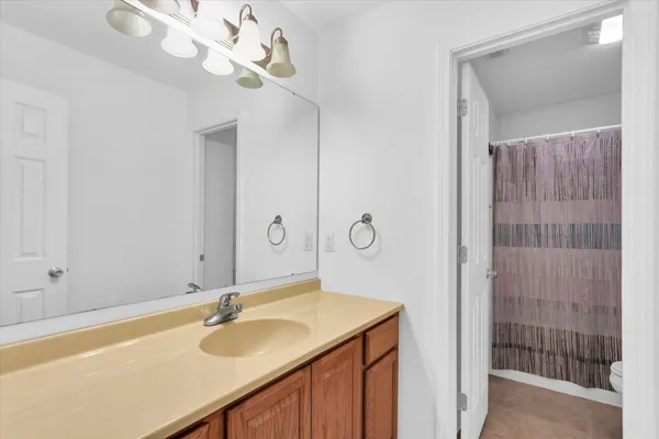 a bathroom with a sink a mirror and a shower