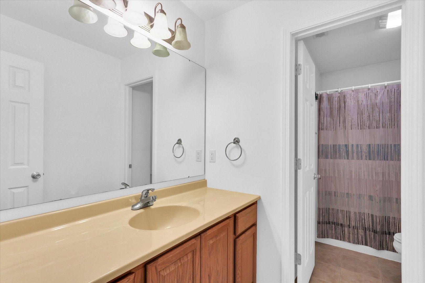 1328 West Ridge Lane Champaign, IL 61822 - Photo 33 of 41 a bathroom with a sink a mirror and a shower