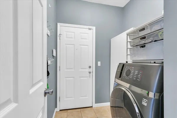 a view of washer and dryer with kitchen in the background