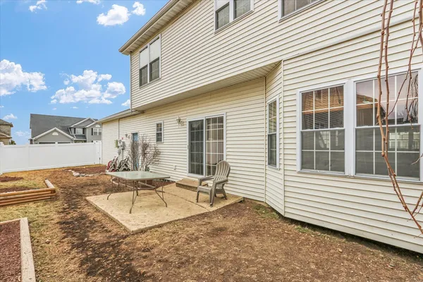 a view of a house with backyard and sitting area