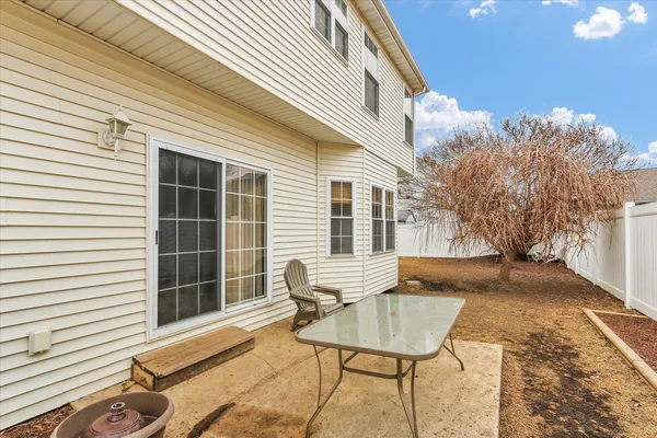 a view of a house with backyard and sitting area