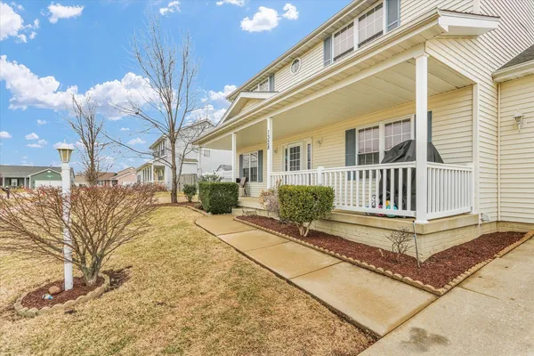 a view of a house with a yard in front of it