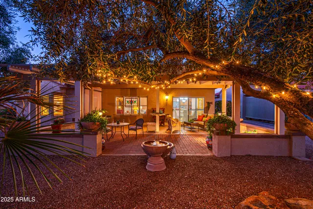 a backyard of a house with barbeque oven table and chairs