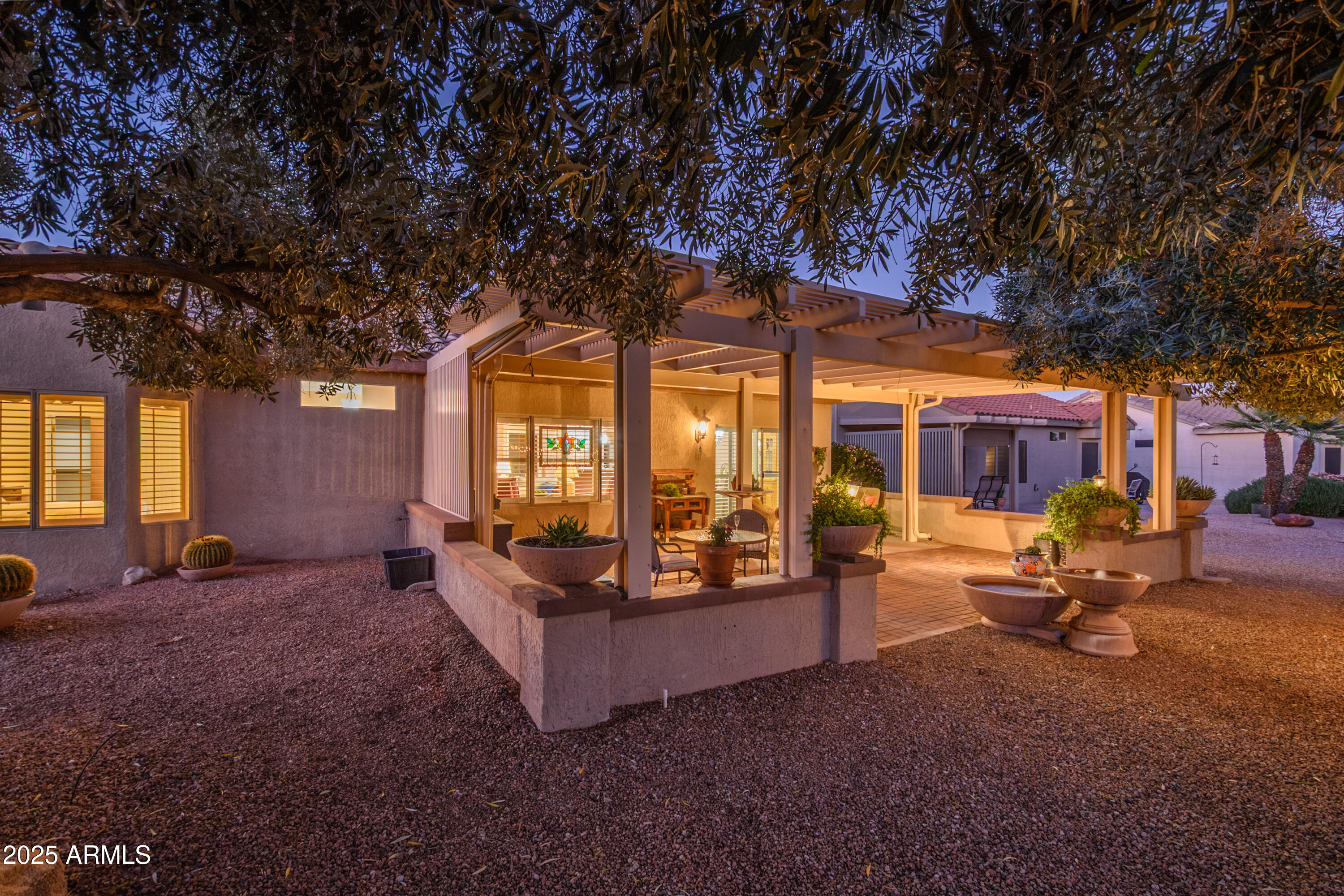 15883 West Cisa Rio Lane Surprise, AZ 85374 - Photo 10 of 45 a view of a house with a large tree and a yard