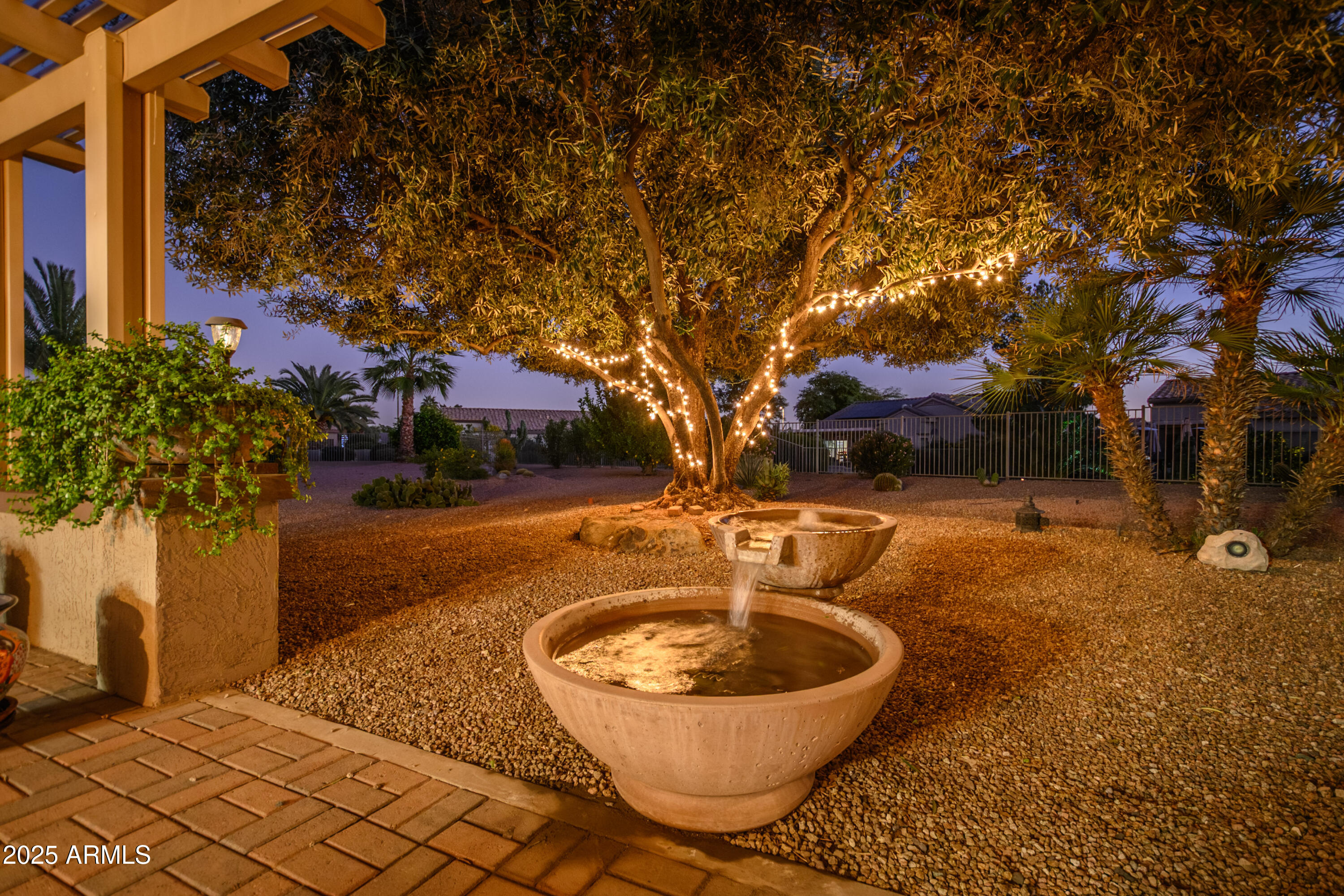 15883 West Cisa Rio Lane Surprise, AZ 85374 - Photo 15 of 45 a backyard of a house with table and chairs