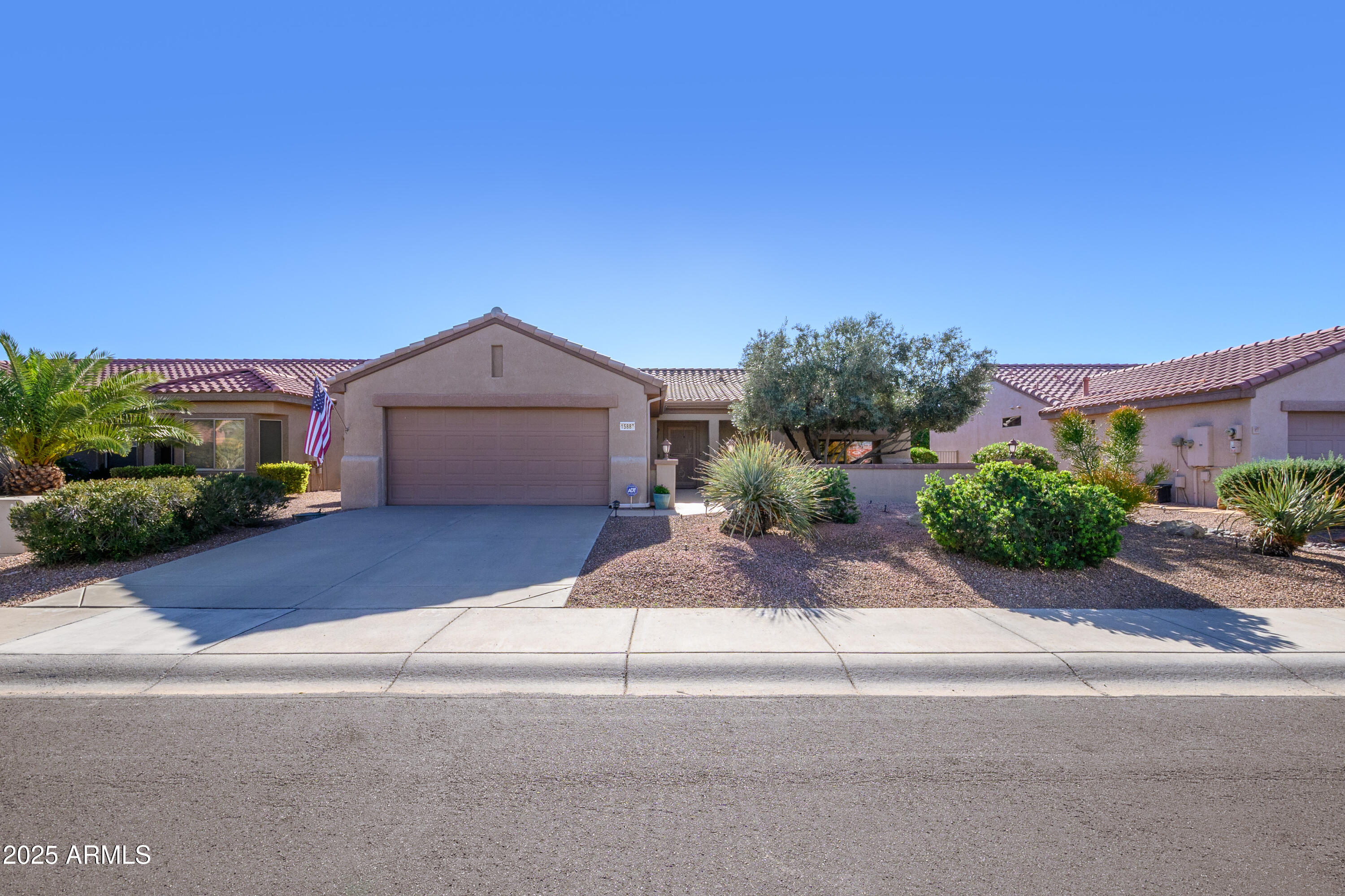 15883 West Cisa Rio Lane Surprise, AZ 85374 - Photo 17 of 45 a front view of a house with a yard and a garage