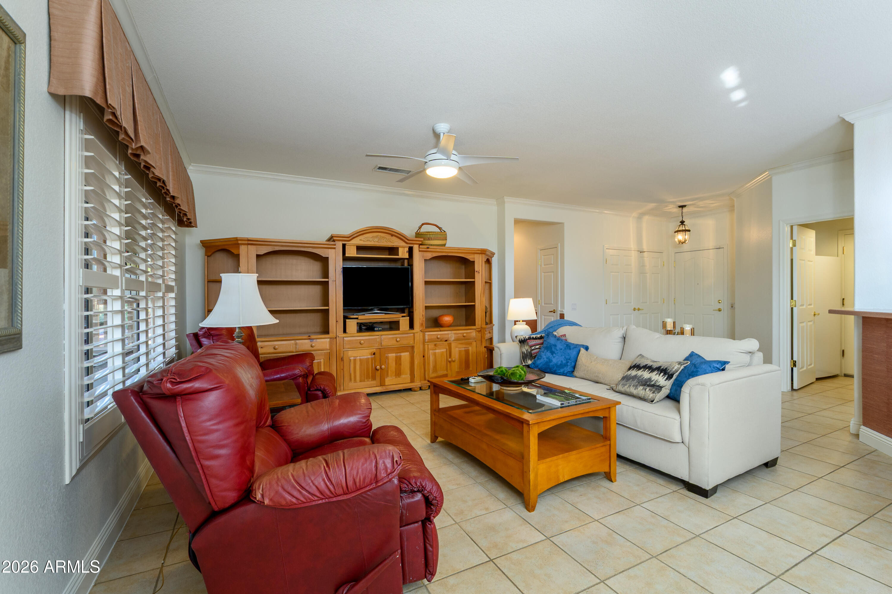 15883 West Cisa Rio Lane Surprise, AZ 85374 - Photo 21 of 45 a living room with furniture ceiling fan and a rug