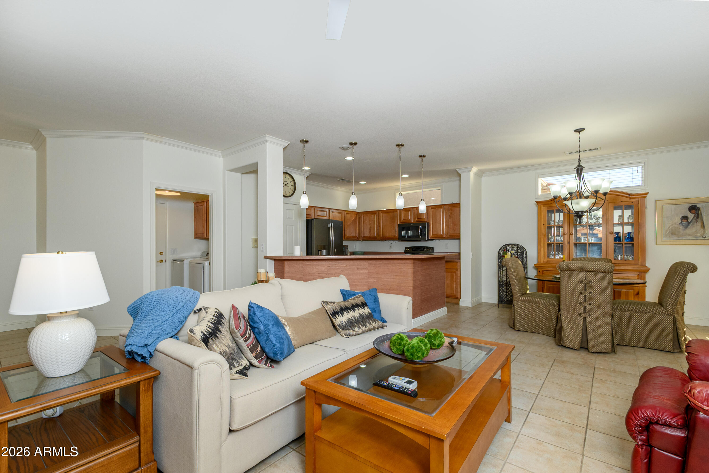 15883 West Cisa Rio Lane Surprise, AZ 85374 - Photo 22 of 45 a living room with furniture kitchen view and a chandelier