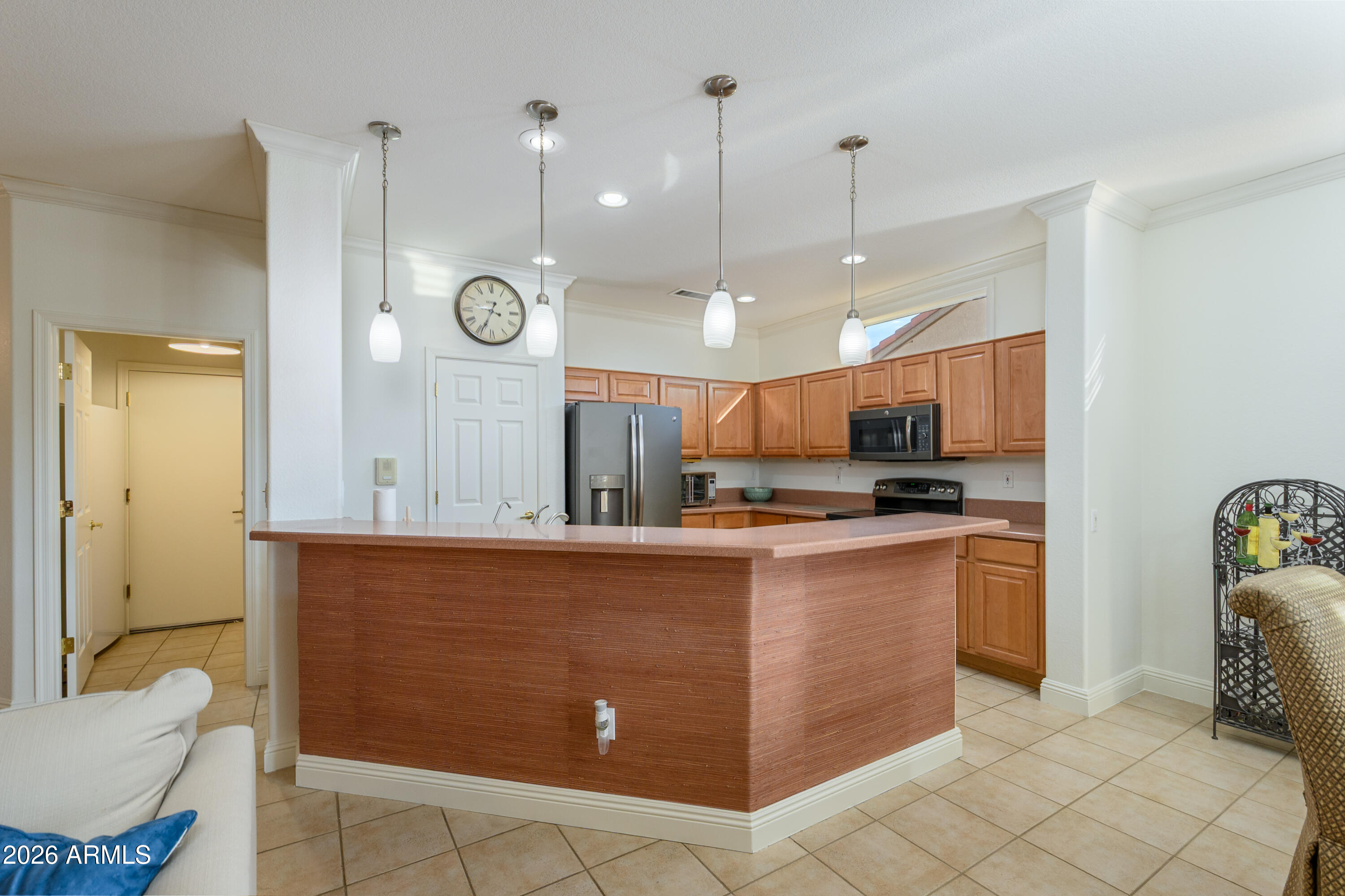15883 West Cisa Rio Lane Surprise, AZ 85374 - Photo 25 of 45 a kitchen with stainless steel appliances kitchen island granite countertop a refrigerator a sink and a stove